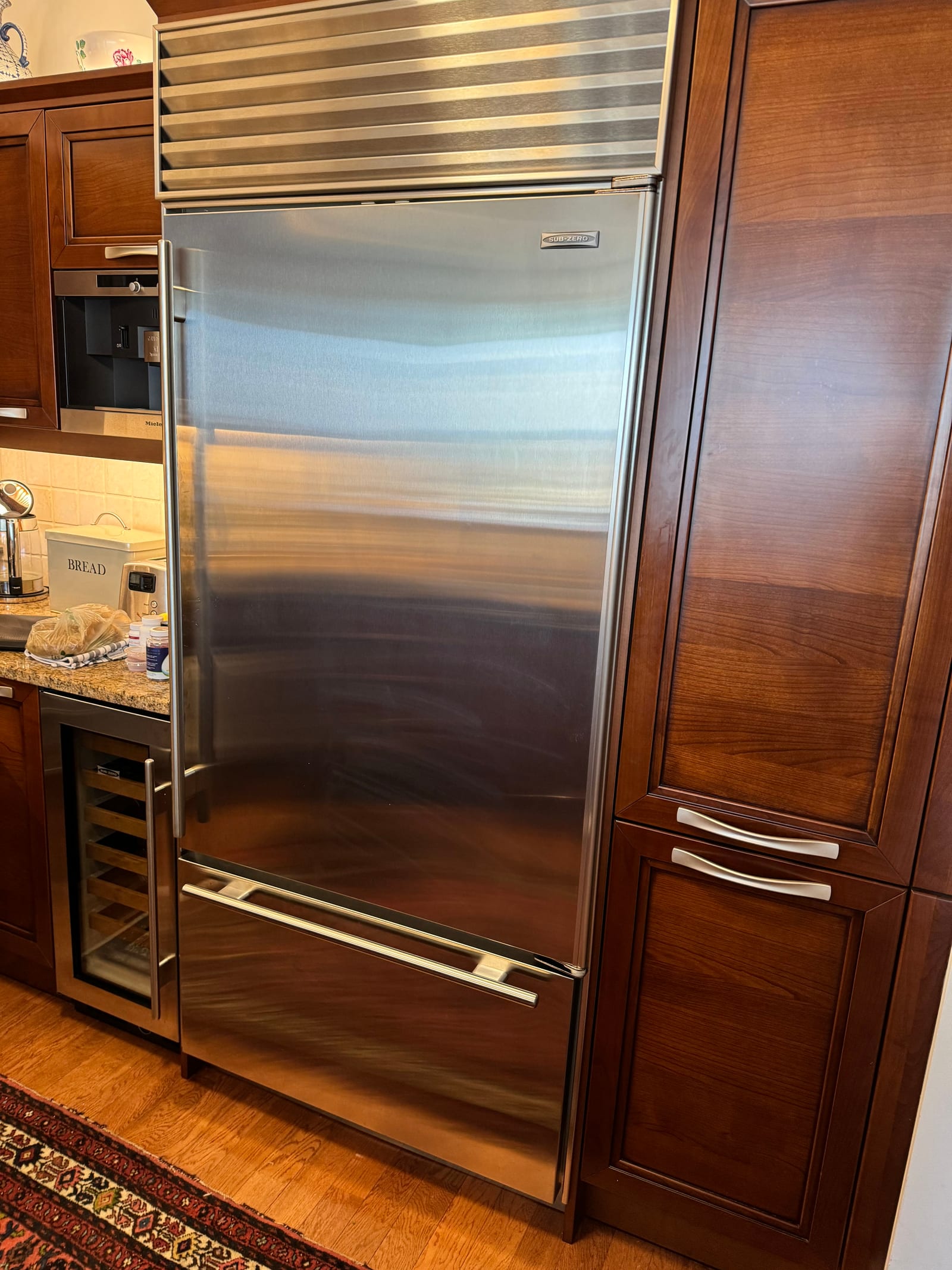 Sub-Zero refrigerator and wine cooler in NYC luxury kitchen — real repair work